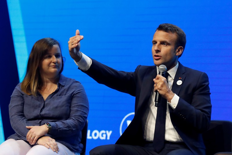 French President Emmanuel Macron talks to start-ups at VivaTech fair in Paris