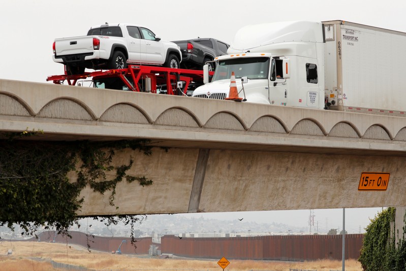 Transport trucks carrying Toyota trucks from Mexico cross into the United States at the Otay Mesa border crossing in San Diego, California