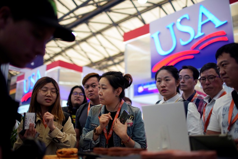 FILE PHOTO: People visit U.S. food booths at SIAL food innovation exhibition, in Shanghai