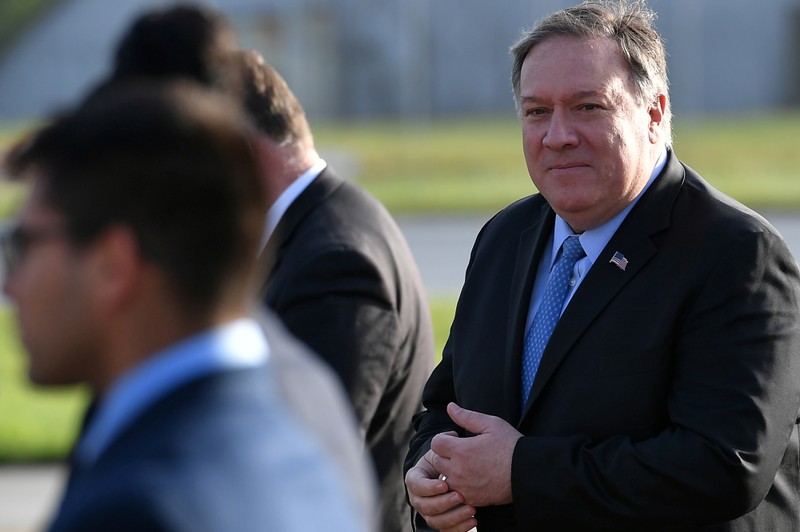FILE PHOTO: U.S. Secretary of State Mike Pompeo walks to board a plane before departing from London Stansted Airport,