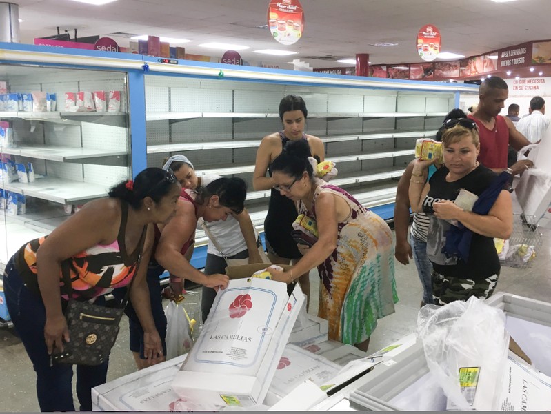 People buy chicken in a supermarket in Havana
