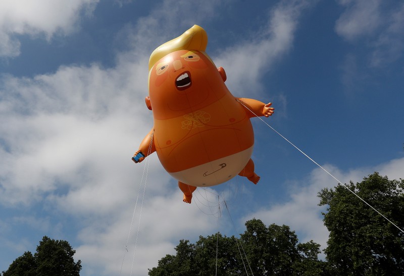 FILE PHOTO: Demonstrators float a blimp portraying U.S. President Donald Trump, above Parliament Square, during the visit by Trump and First Lady Melania Trump in London
