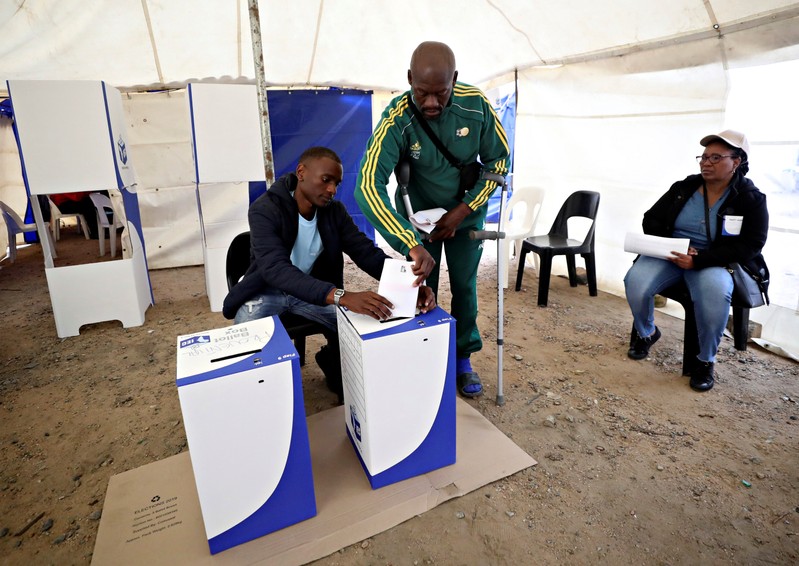 A voter casts his ballot at a polling station during the South Africa'sÊparliamentary and provincial elections, in Alexandra township, Johannesburg