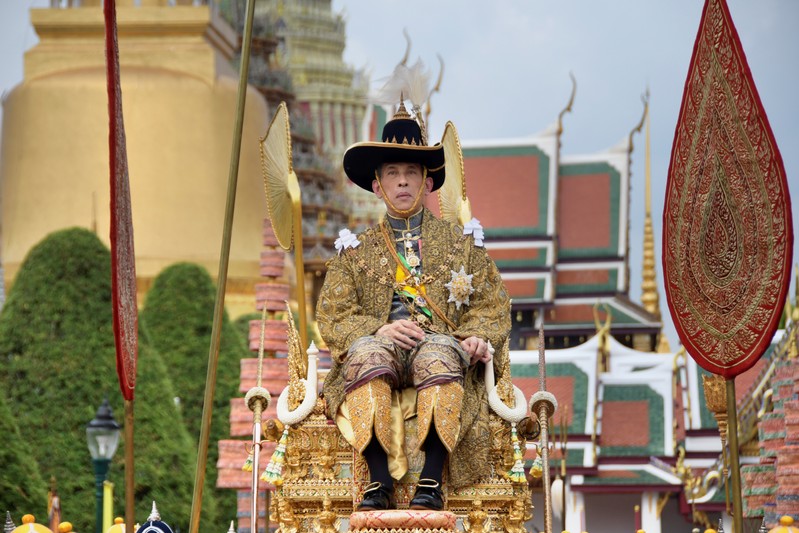 Thailand's King Maha Vajiralongkorn is transported on the royal palanquin by royal bearers during his visit to the Temple of the Emerald Buddha to proclaim himself the Royal Patron of Buddhism, inside the Grand Palace in Bangkok
