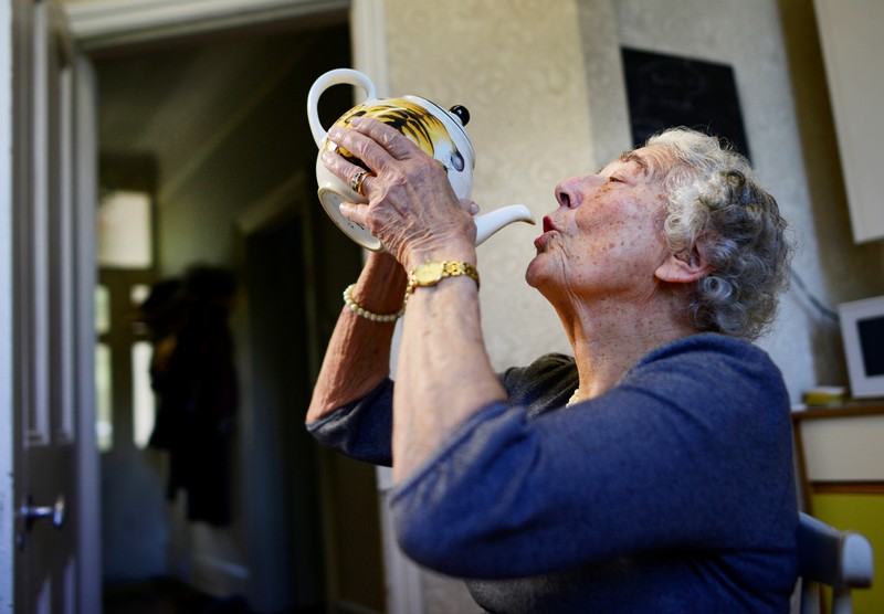 FILE PHOTO: British children's writer and illustrator Judith Kerr drinks from a tea pot as she recreates a scene from her bestselling picture book 
