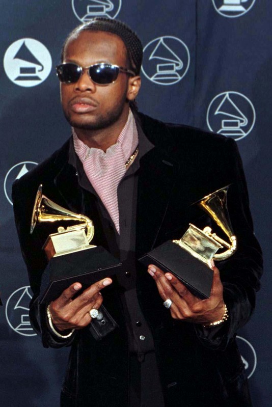 FILE PHOTO: Prakazrel Michel of the band The Fugees, poses with his Grammy awards for Best R & B Performance by a Duo or Group category for 