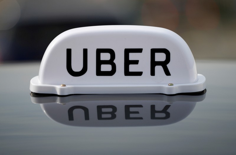 FILE PHOTO: The Logo of taxi company Uber is seen on the roof of a private hire taxi in Liverpool