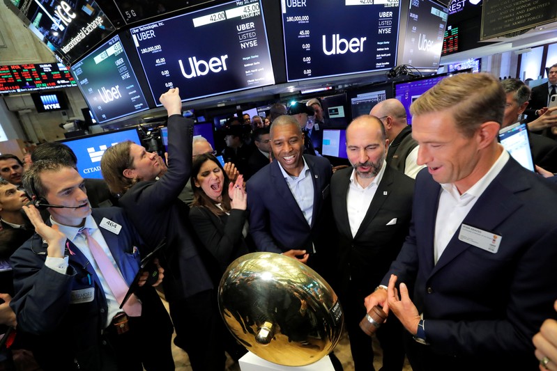FILE PHOTO: Uber Technologies Inc. CEO Dara Khosrowshahi and co-founder Ryan Graves ring bell on trading floor of NYSE during the company's IPO in New York