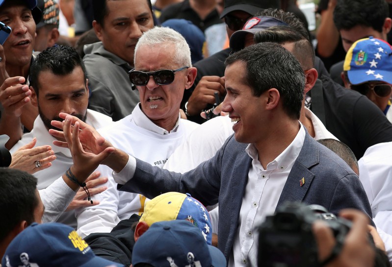 Venezuelan opposition leader Juan Guaido greets supporters as he leaves after a rally in support of the Venezuelan National Assembly and against the government of Venezuela's President Nicolas Maduro in Caracas