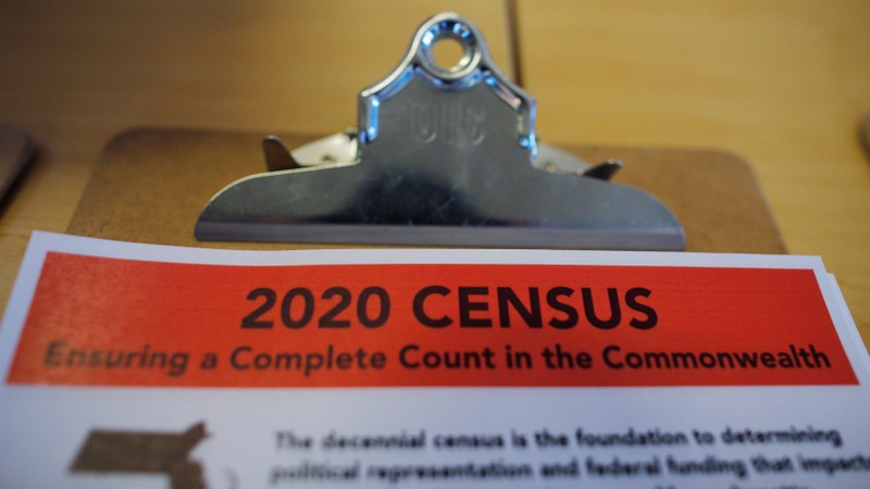 An informational pamphlet is displayed at an event for community activists and local government leaders to mark the one-year-out launch of the 2020 Census efforts in Boston