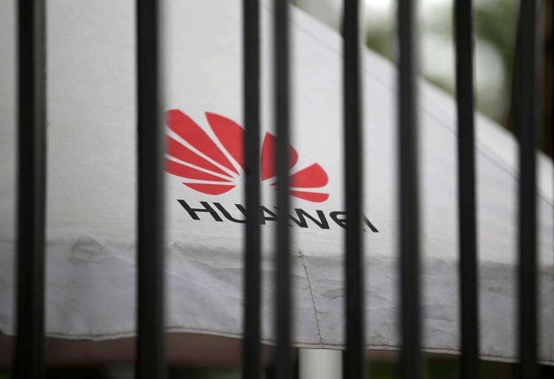 FILE PHOTO: A Huawei logo is seen outside the fence at its headquarters in Shenzhen