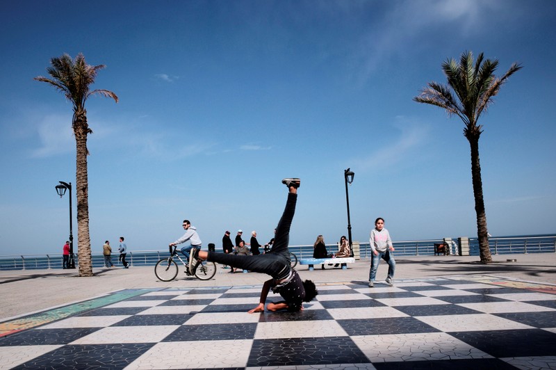 FILE PHOTO: A breakdancer performs at Beirut's Corniche, a seaside promenade in Beirut