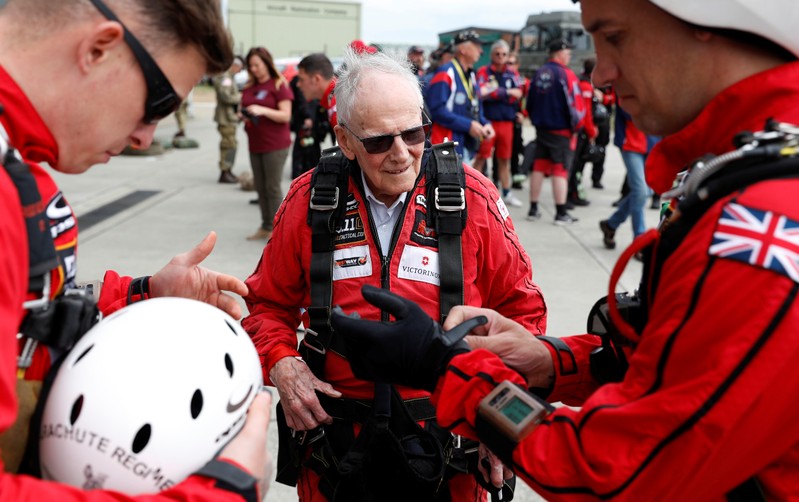 D-Day veteran Harry Read makes his final preparations with members of the Army Parachute Display Team before flying to Normandy in France