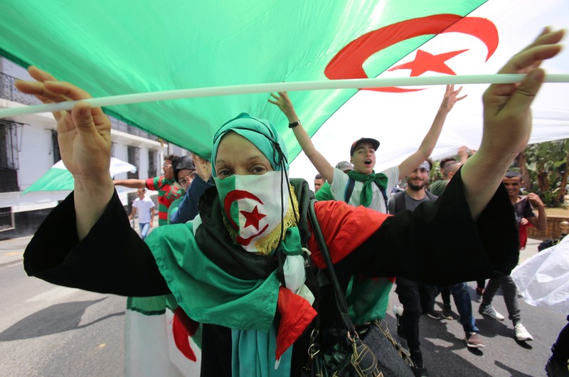 A demonstrator gestures during a protest demanding the removal of the ruling elite in Algiers