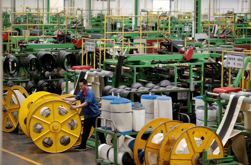 An employee works on the production line of a tyre factory under Tianjin Wanda Tyre Group in Xingtai