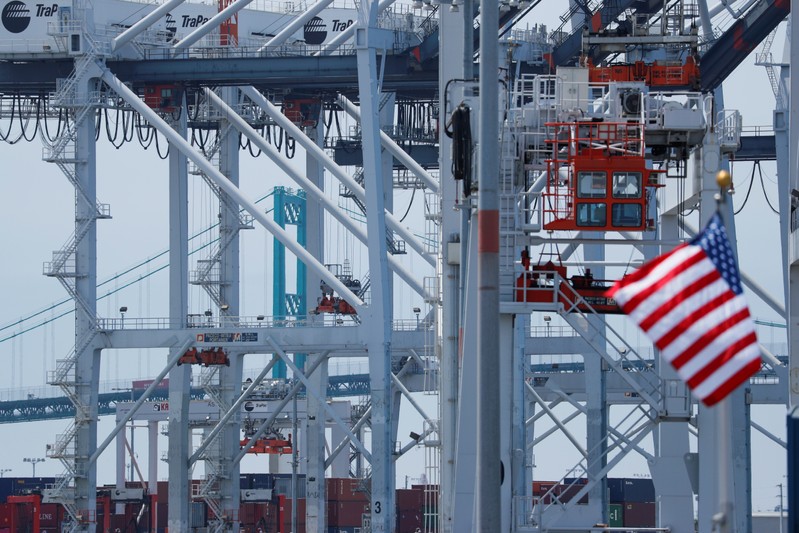 FILE PHOTO: The U.S. flag flies at the Port of Los Angeles in Los Angeles, California