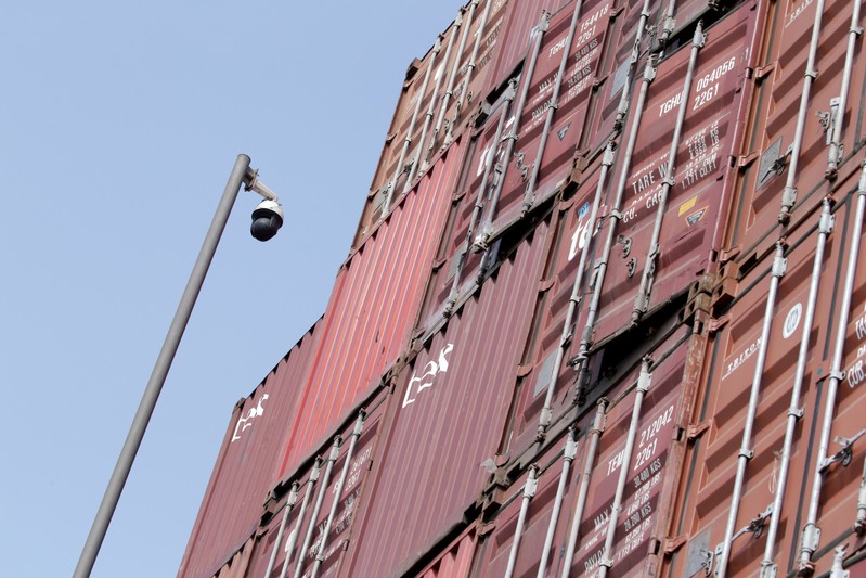 A surveillance camera is seen next to containers at a logistics center near Tianjin Port