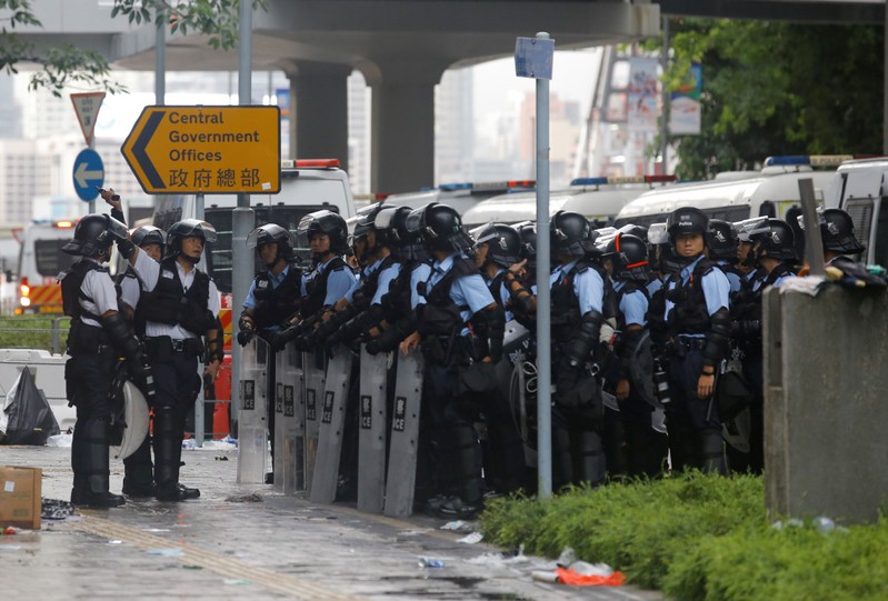 Riot police gather outside the Legislative Council, following a day of violence in Hong Kong
