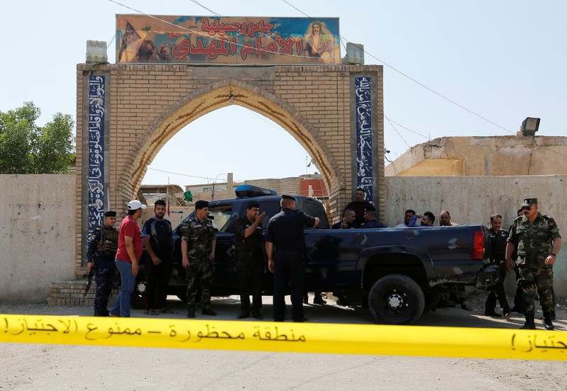 Police tape cordon is seen at the site of a bomb attack at a Shi'ite Muslim mosque in the Baladiyat neighbourhood of Baghdad
