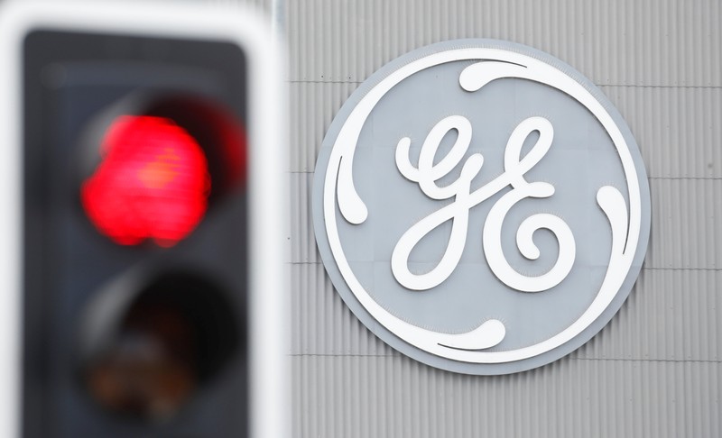 FILE PHOTO: A traffic light is seen in front of a logo of General Electric at the company's plant in Birr