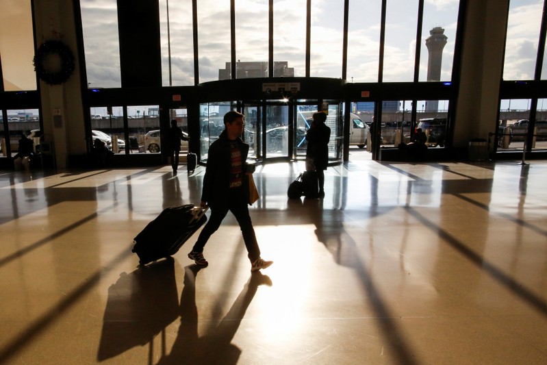 FILE PHOTO: Travelers make their way through Newark Liberty International Airport in Newark, New Jersey