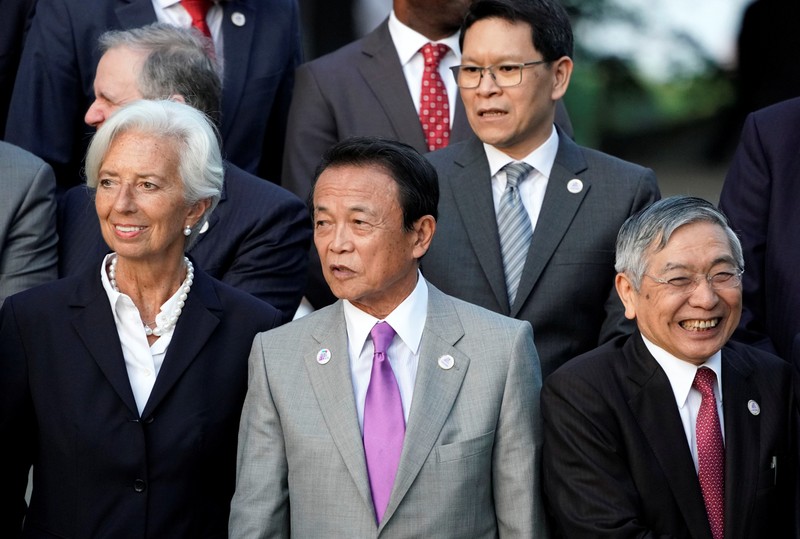 Japan's Finance Minister Taro Aso stands next to IMF Managing Director Christine Lagarde and Bank of Japan Governor Haruhiko Kuroda before a family photo during the G20 finance ministers and central bank governors meeting, in Fukuoka