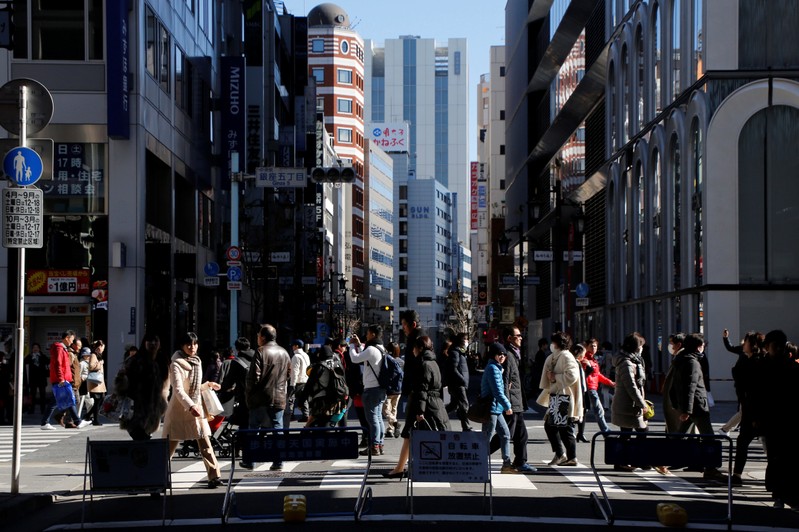FILE PHOTO: People walk on a street at Tokyo's Ginza shopping district