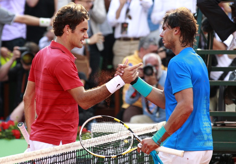 FILE PHOTO - Nadal of Spain shakes hands with Federer of Switzerland after winning their men's final at the French Open tennis tournament at the Roland Garros stadium in Paris