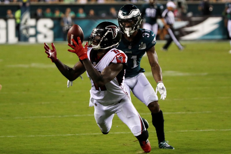 FILE PHOTO: Atlanta Falcons receiver Julio Jones try to make a catch on a long pass in front of Philadelphia Eagles defender Jalen Mills in the third quarter of their NFL football game in Philadelphia