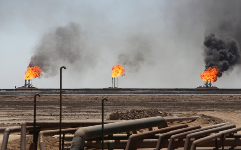 FILE PHOTO: Flames emerge from the flare stacks at the West Qurna-1 oilfield, which is operated by ExxonMobil, near Basra