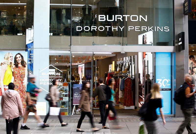 People walk past a Burton and Dorothy Perkins store, owned by Arcadia Group, in central London
