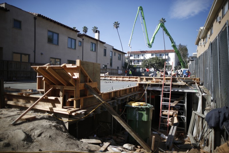 People work on a construction site to build a new apartment building in Los Angeles, California