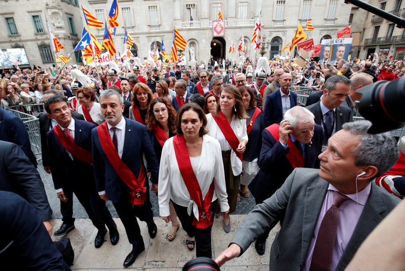 Barcelona's new Mayor Ada Colau walks next to Jaume Collboni, Ernest Maragall and Manuel Valls after her swearing-in ceremony, at Sant Jaume square in Barcelona