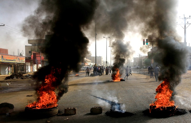 Sudanese protesters use burning tyres to erect a barricade on a street, demanding that the country's Transitional Military Council hand over power to civilians, in Khartoum