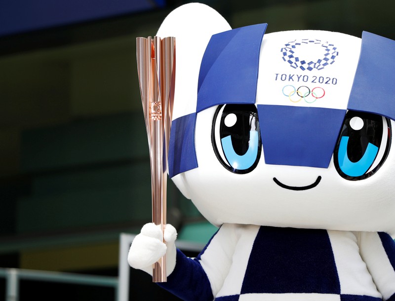 Tokyo 2020 Olympic Games mascot Miraitowa holds the torch of the Tokyo 2020 Olympic Games during a Torch Relay event to mark the 300-day milestone to the starting date of the torch relay, in Tokyo
