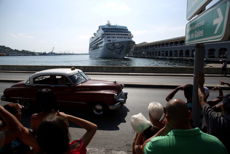 FILE PHOTO: People look at the arrival of U.S. Carnival cruise ship Adonia at the Havana bay, the first cruise liner to sail between the United States and Cuba since Cuba's 1959 revolution