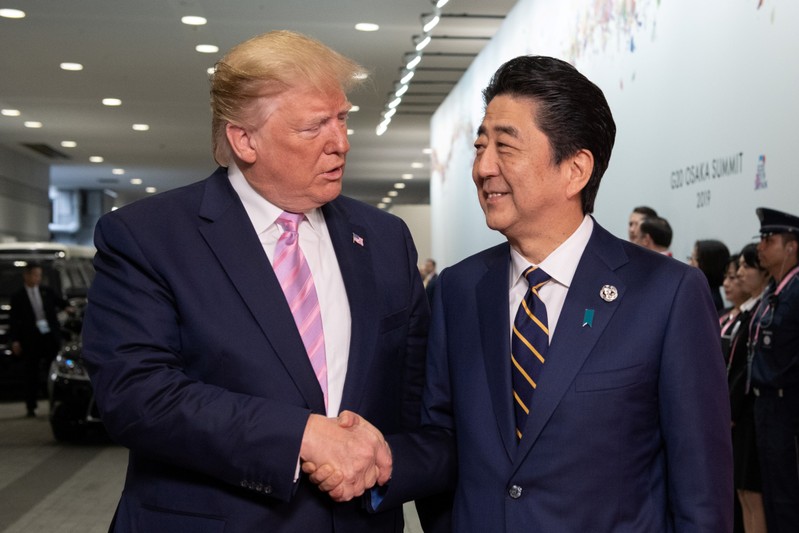 U.S President Donald Trump is greeted by Japan's Prime Minister, Shinzo Abe, as he arrives on the first day of the G20 summit in Osaka