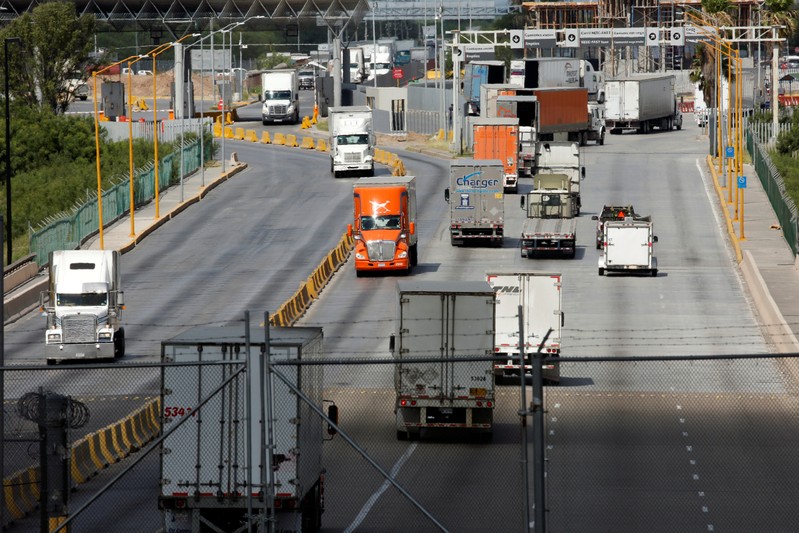 Trucks cross the borderline into the U.S. and into Mexico at the World Trade Bridge, as seen from Laredo