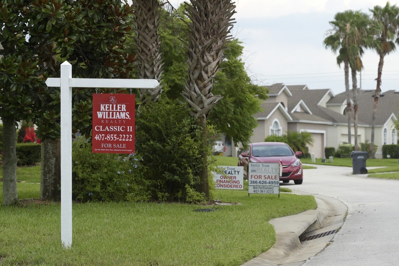 FILE PHOTO: For Sale signs stand in front of houses in a neighborhood in Davenport