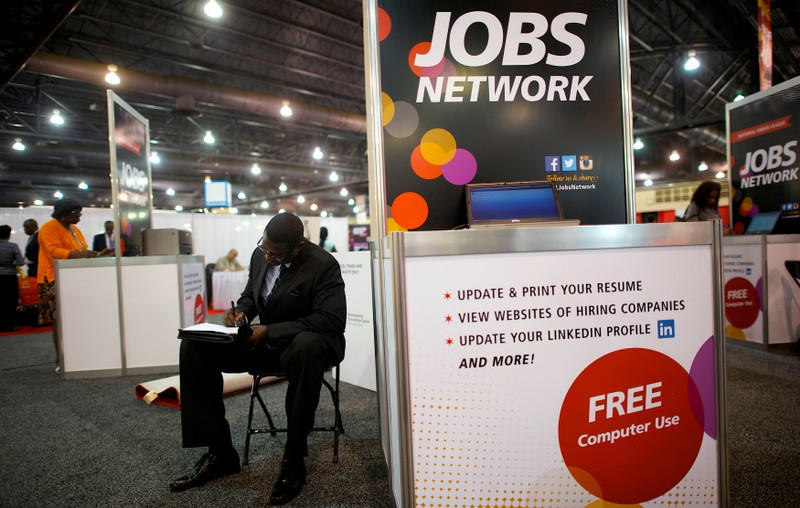 File photo of a job-seeker completing an application at a career fair in Philadelphia