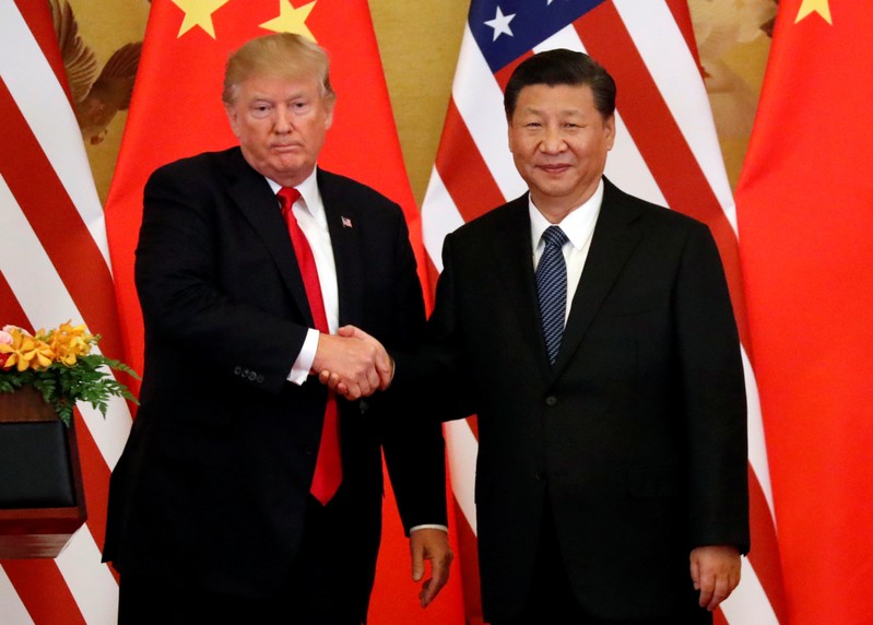 FILE PHOTO: U.S. President Donald Trump and China's President Xi Jinping make joint statements at the Great Hall of the People in Beijing