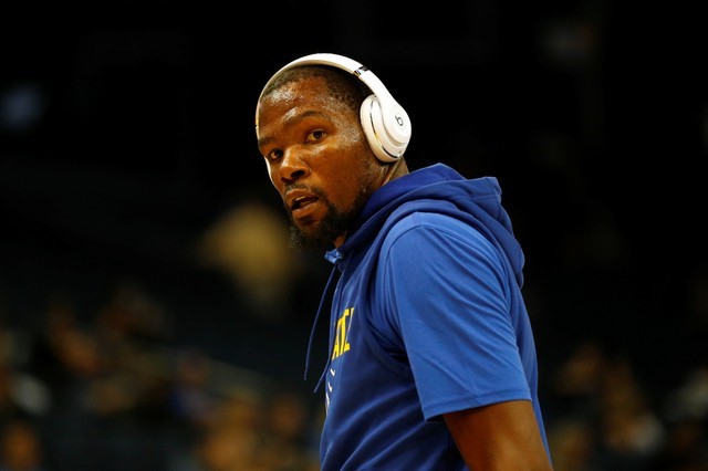 FILE PHOTO: Durant of the Golden State Warriors warm up before his NBA pre-season game against the Denver Nuggets at Oracle Arena in Oakland, California