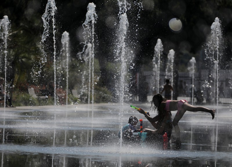 People cool off in a fountain in Nice as a heatwave hits much of the country