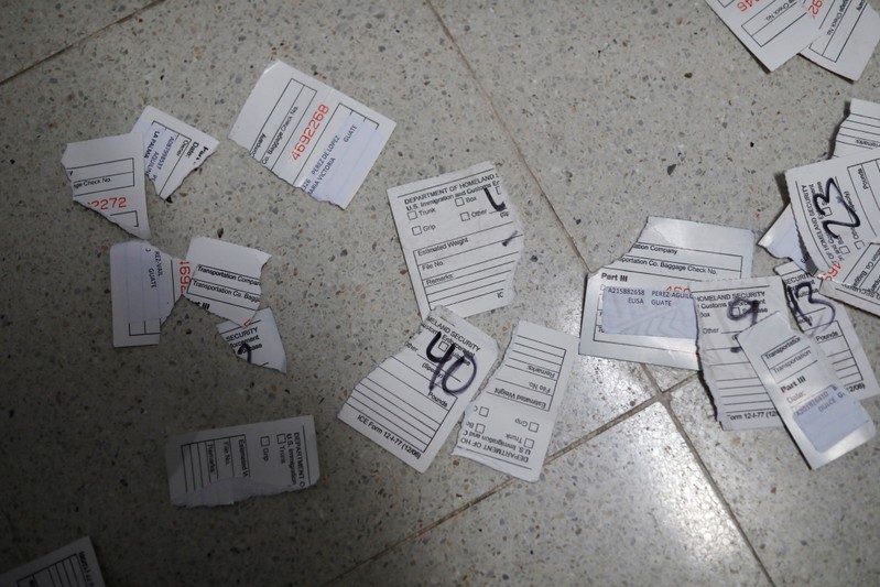 FILE PHOTO: Torn bag tags are seen on the floor after the arrival of Guatemalan migrants from the United States, in Guatemala City