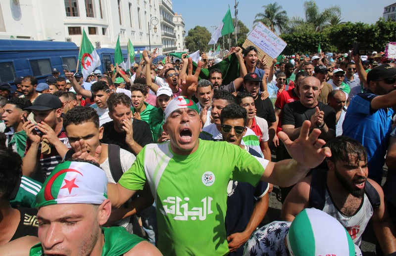 Demonstrators chant slogans during a protest demanding the removal of the ruling elite in Algiers