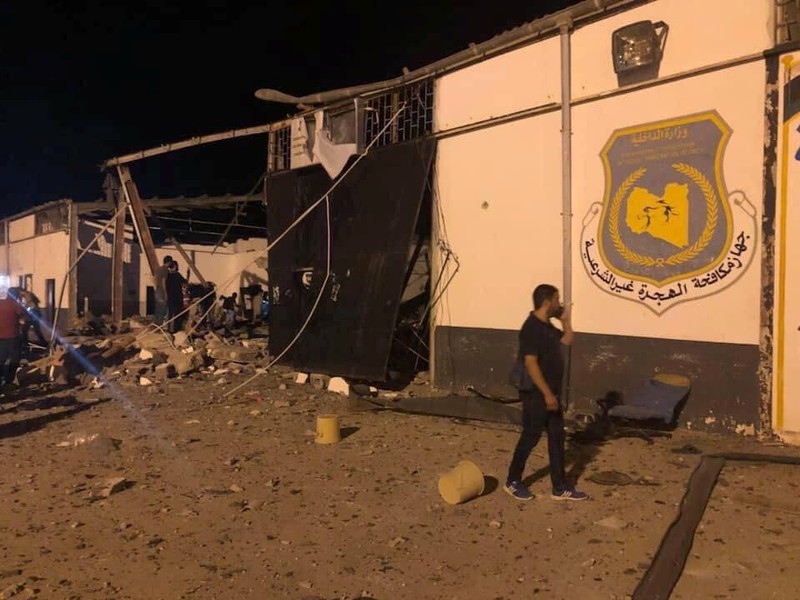 Social media picture of a man walking next to the damaged building of a detention centre for mainly African migrants, after an airstrike, in a suburb of Tripoli