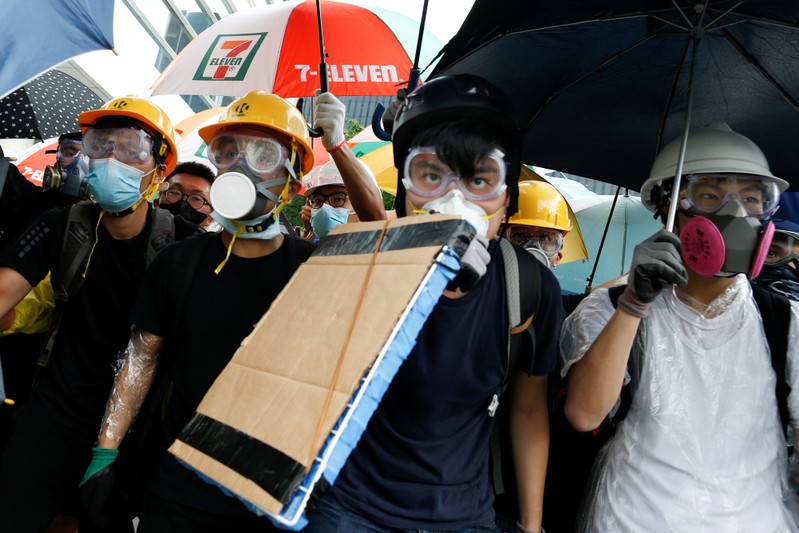 FILE PHOTO: Protesters face riot police during clashes near a flag raising ceremony for the anniversary of Hong Kong handover to China in Hong Kong
