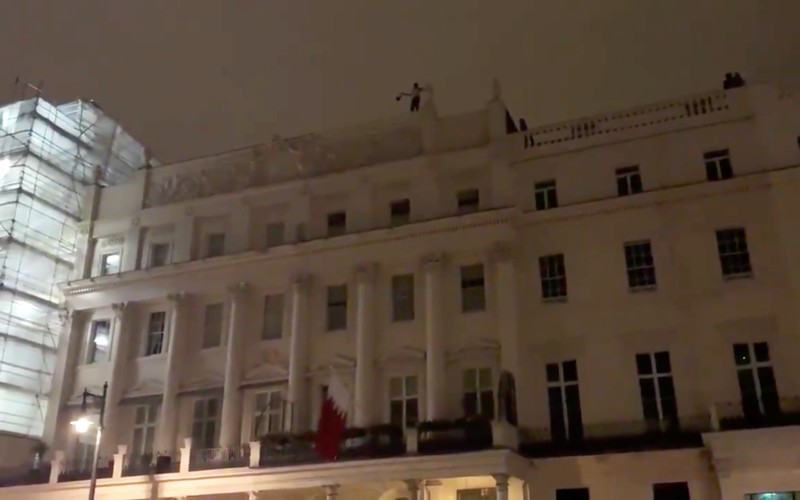 A man is seen on the roof of Bahrain's Embassy in London