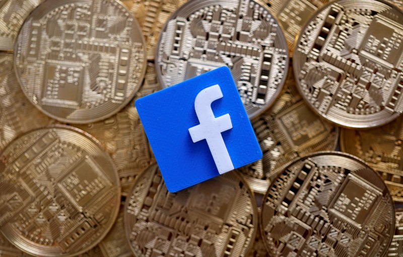 FILE PHOTO: Facebook logo is seen on representations of Bitcoin virtual currency in this illustration picture
