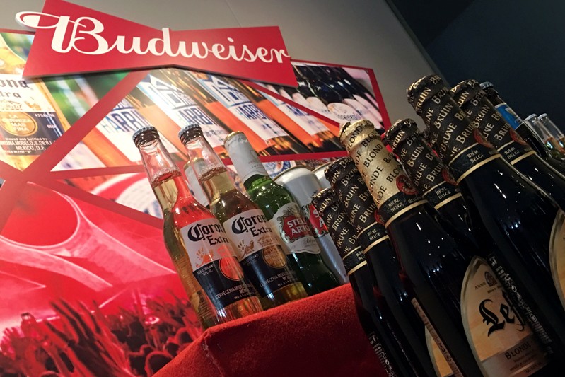 FILE PHOTO: Portfolio beer brands of Budweiser Brewing Company APAC Ltd are displayed during a news conference on the company's IPO in Hong Kong
